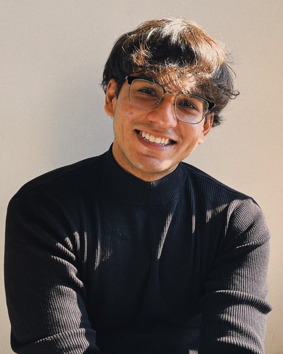 Santhoshkumar Chandrasekar, smiling, in a black sweater